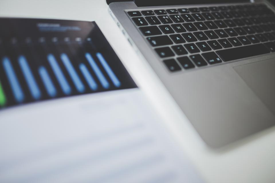 Laptop and chart depicting market analysis