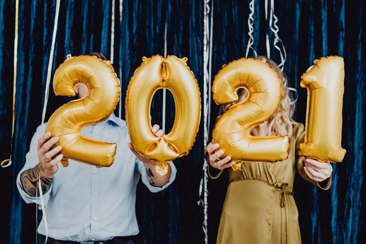 Couple holding balloons header for 2021 real estate forecast